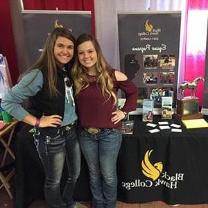 Two girls standing in front of a table